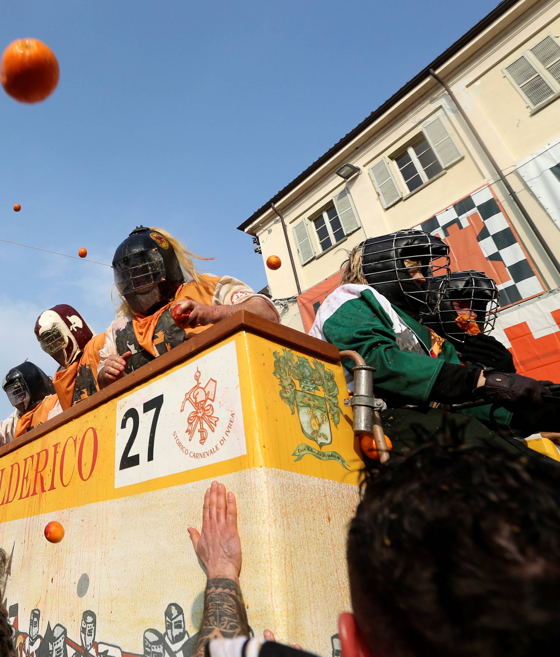 Members of rival teams fight with oranges during an annual carnival battle in the northern Italian town of Ivrea