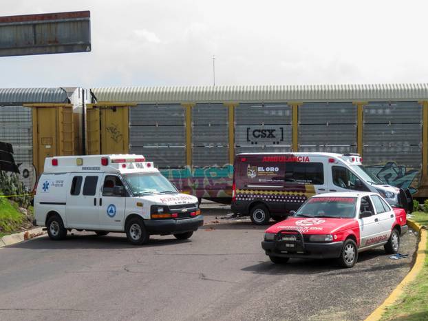 Authorities work at the scene where a passenger bus was struck by a train, in Atlacomulco