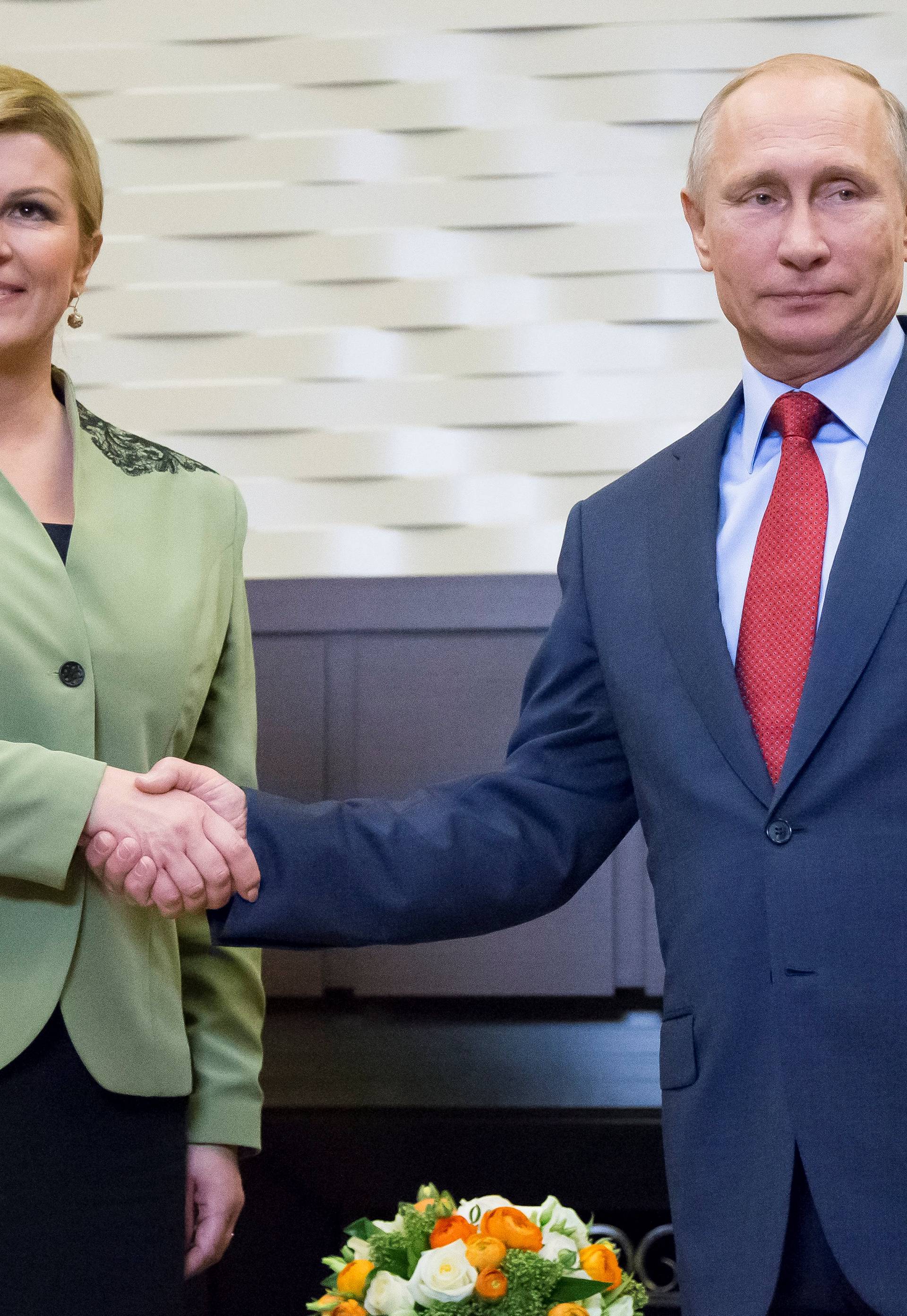 Croatian President Kolinda Grabar-Kitarovic and Putin pose for a photo during their meeting in Sochi
