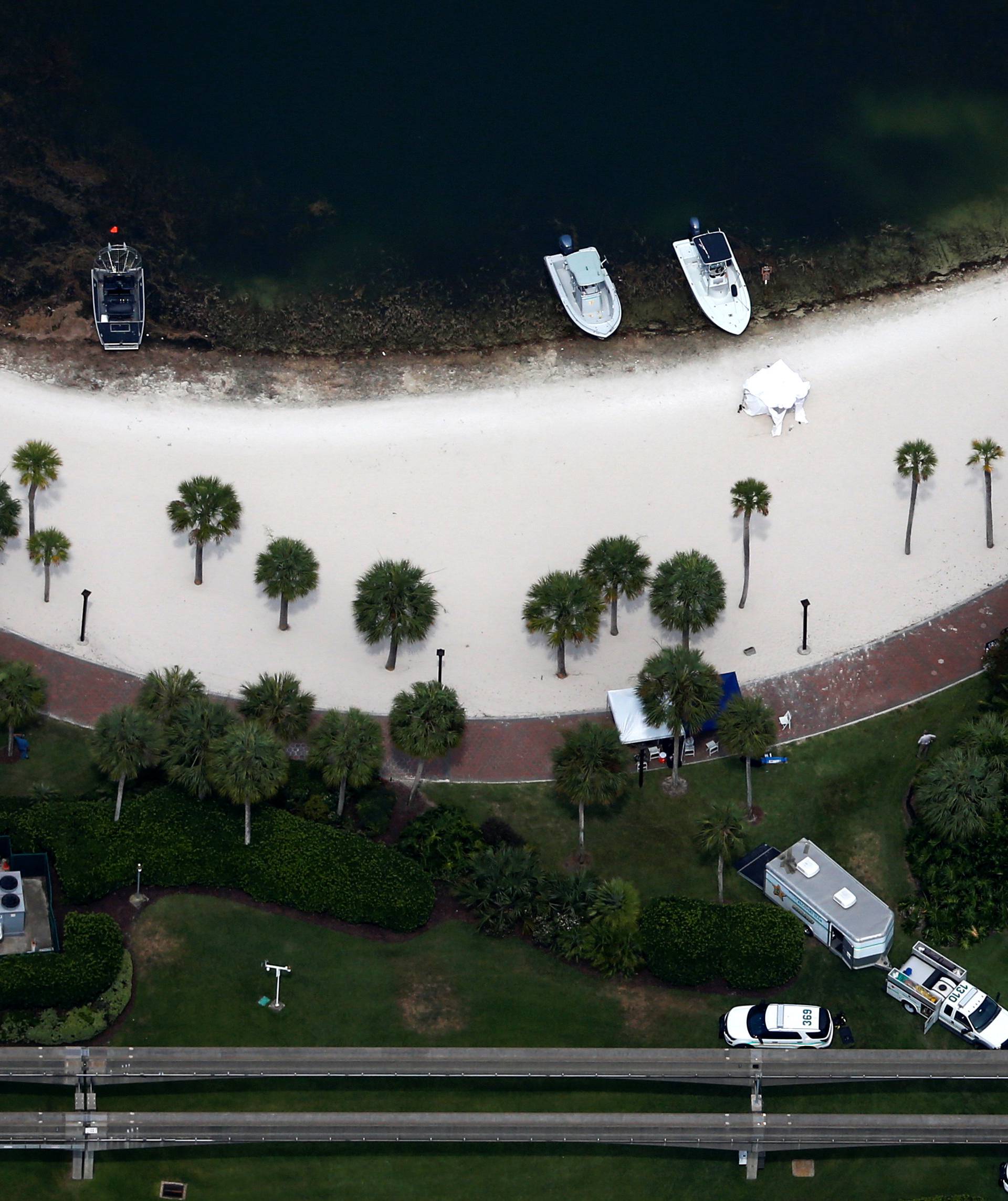 Rescue boats are seen near shoreline at Grand Floridian after boy dragged by an alligator into lagoon at Walt Disney World in Orlando, Florida