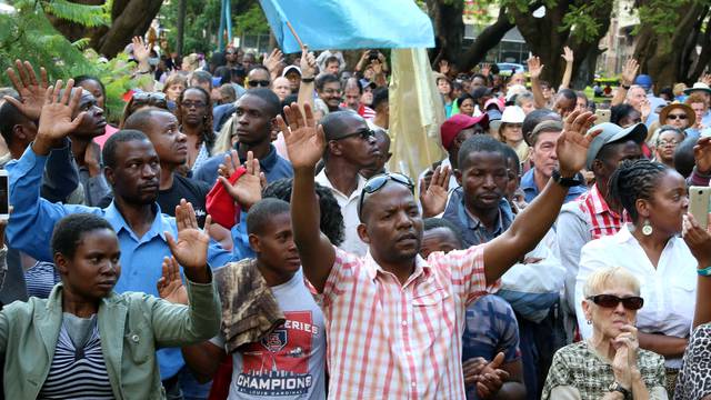 Residents attend a prayer meeting called to celebrate after Zimbabwean President Robert Mugabe was dismissed as party leader of the ruling ZANU-PF's central committee in Harare