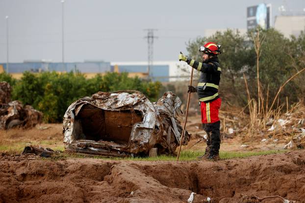 Members of the military search for bodies of people missing after heavy rains, in Quart de Poblet
