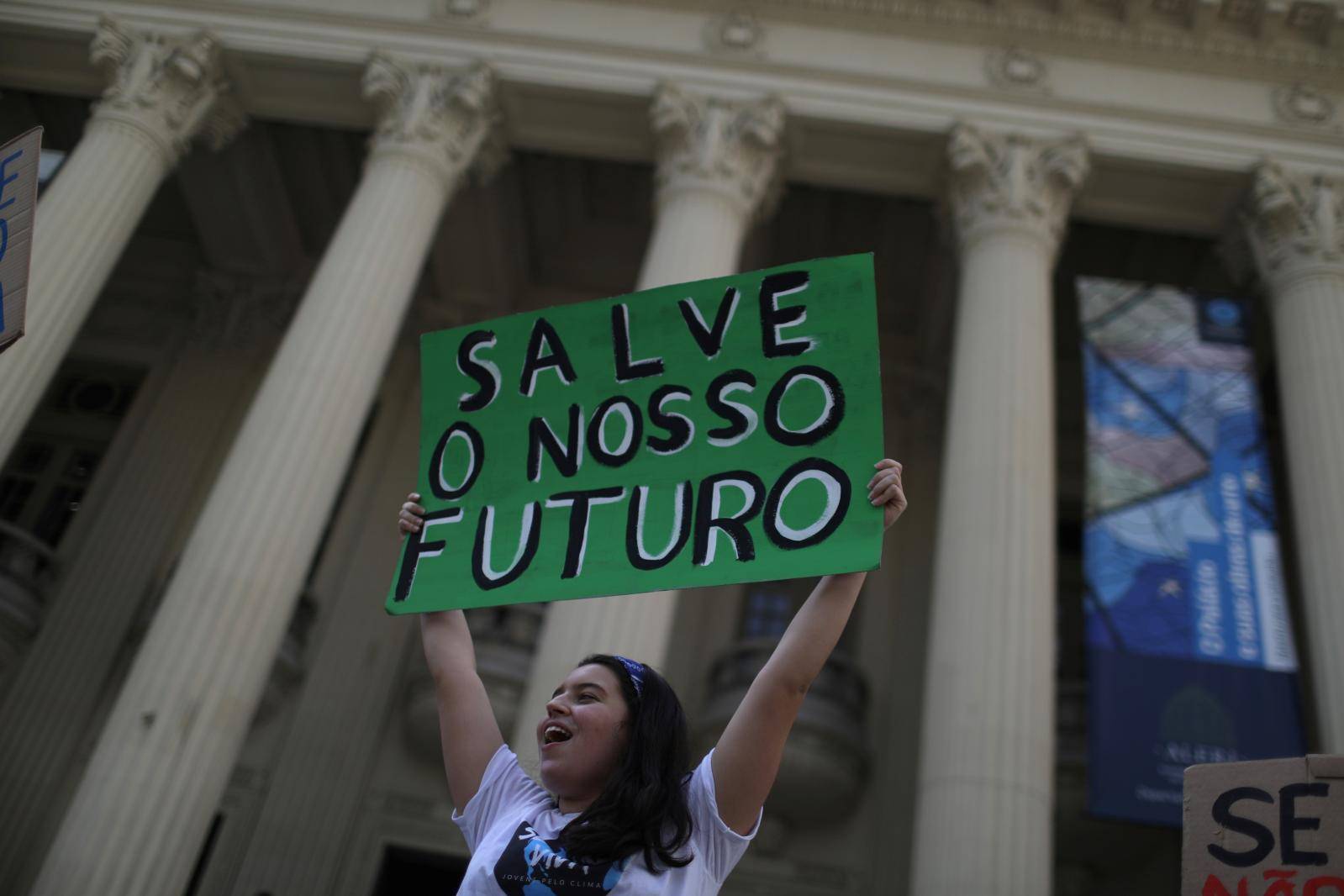A demonstrator takes part in the world march for climate change and the environment, called by the organization Fridays for Future outside the Rio de Janeiro State Assembly