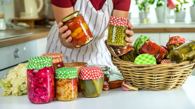 Woman jar preserve vegetables in the kitchen. Selective focus.