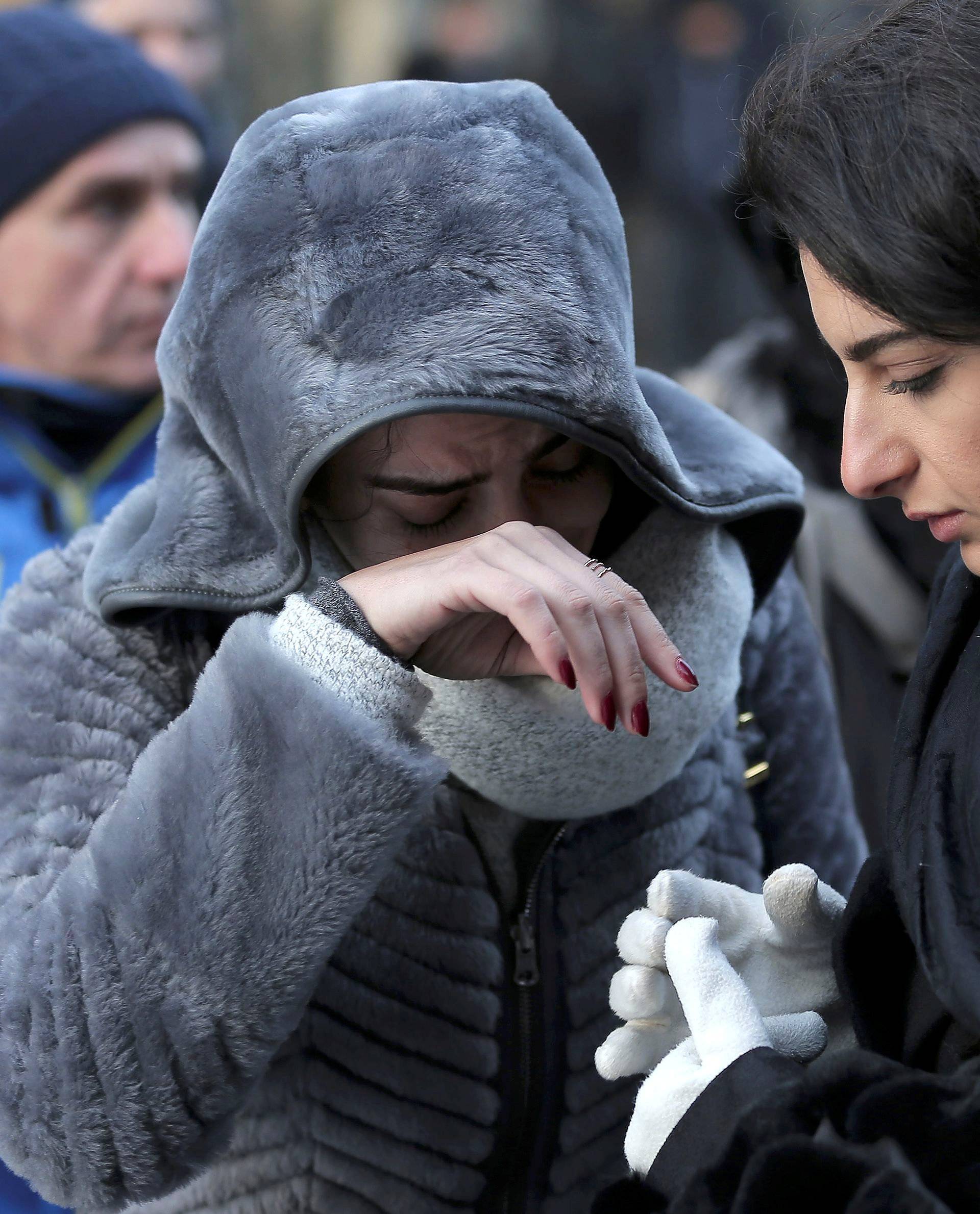 Women who survived an attack by a gunman, react outisde the Reina nightclub by the Bosphorus, in Istanbul