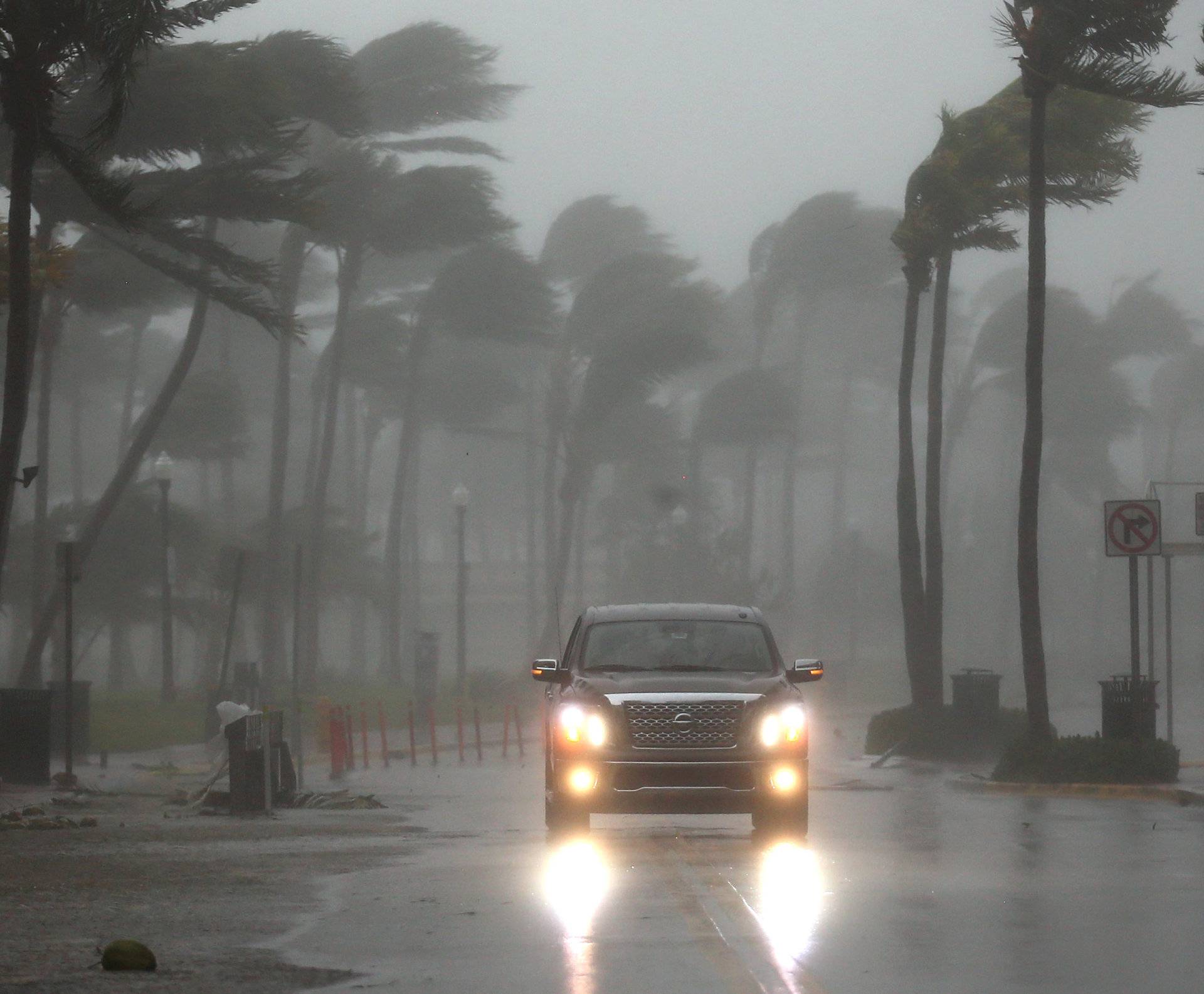 A vehicle drives along Ocean Drive in South Beach as Hurricane Irma arrives at south Florida, in Miami Beach