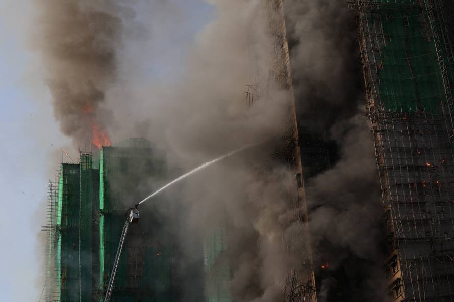 Flames engulf bamboo scaffolding across multiple buildings at Wang Fuk Court housing estate, in Tai Po