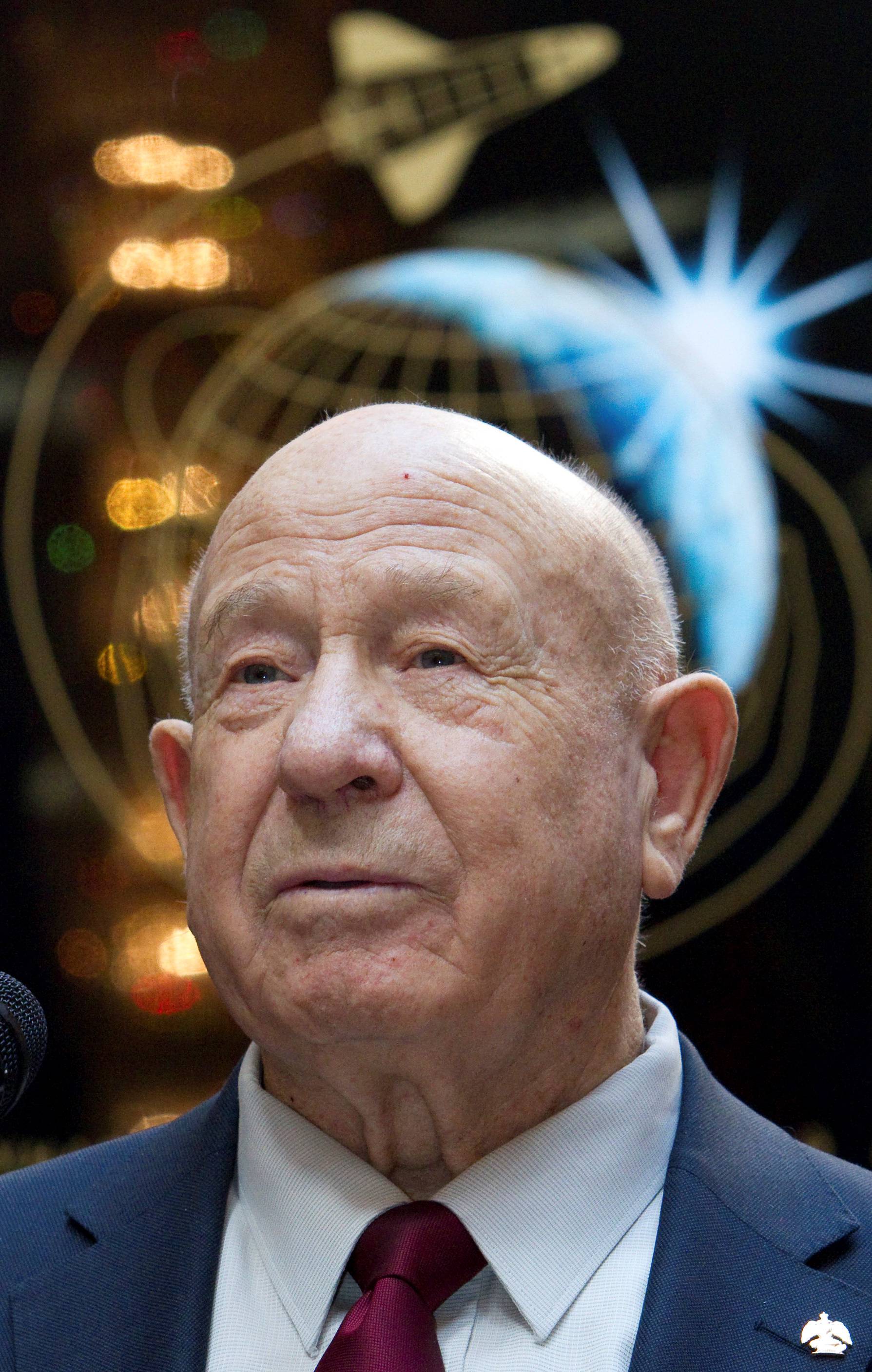 FILE PHOTO: Leonov, the first man to conduct a space walk in 1965, attends a photo exhibition in Moscow
