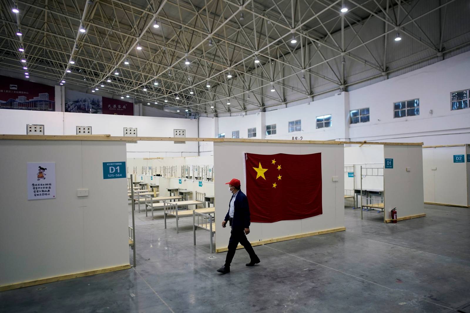 FILE PHOTO: Volunteer walks inside a convention center that was used as a makeshift hospital in Wuhan