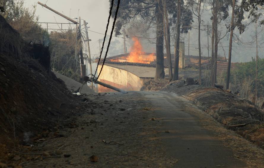 View of a burning house at Caminho do Meio during the forest fires in Funchal