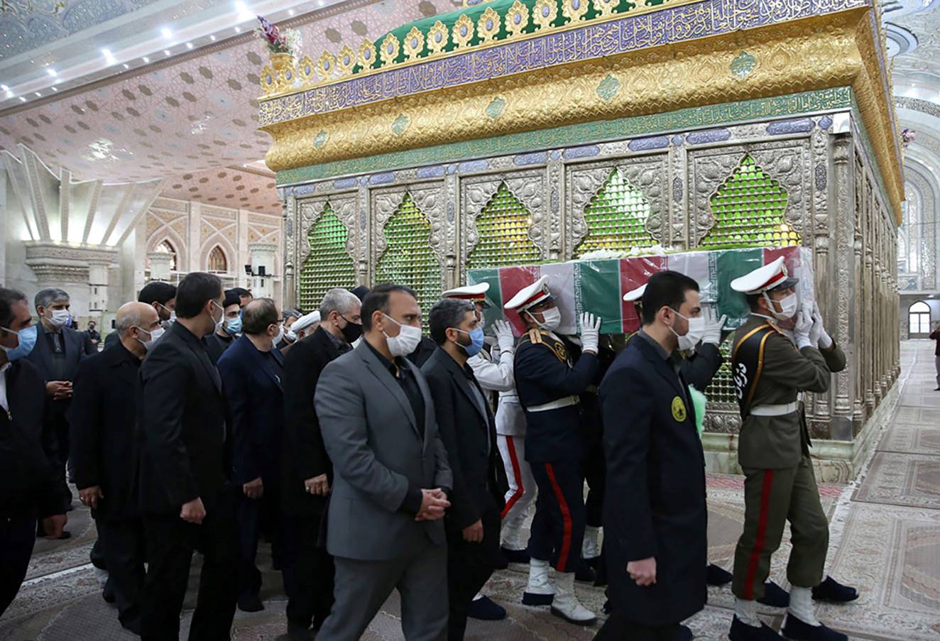 Members of Iranian forces carry the coffin of Iranian nuclear scientist Mohsen Fakhrizadeh at the Imam Khomeini's Shrine in Tehran