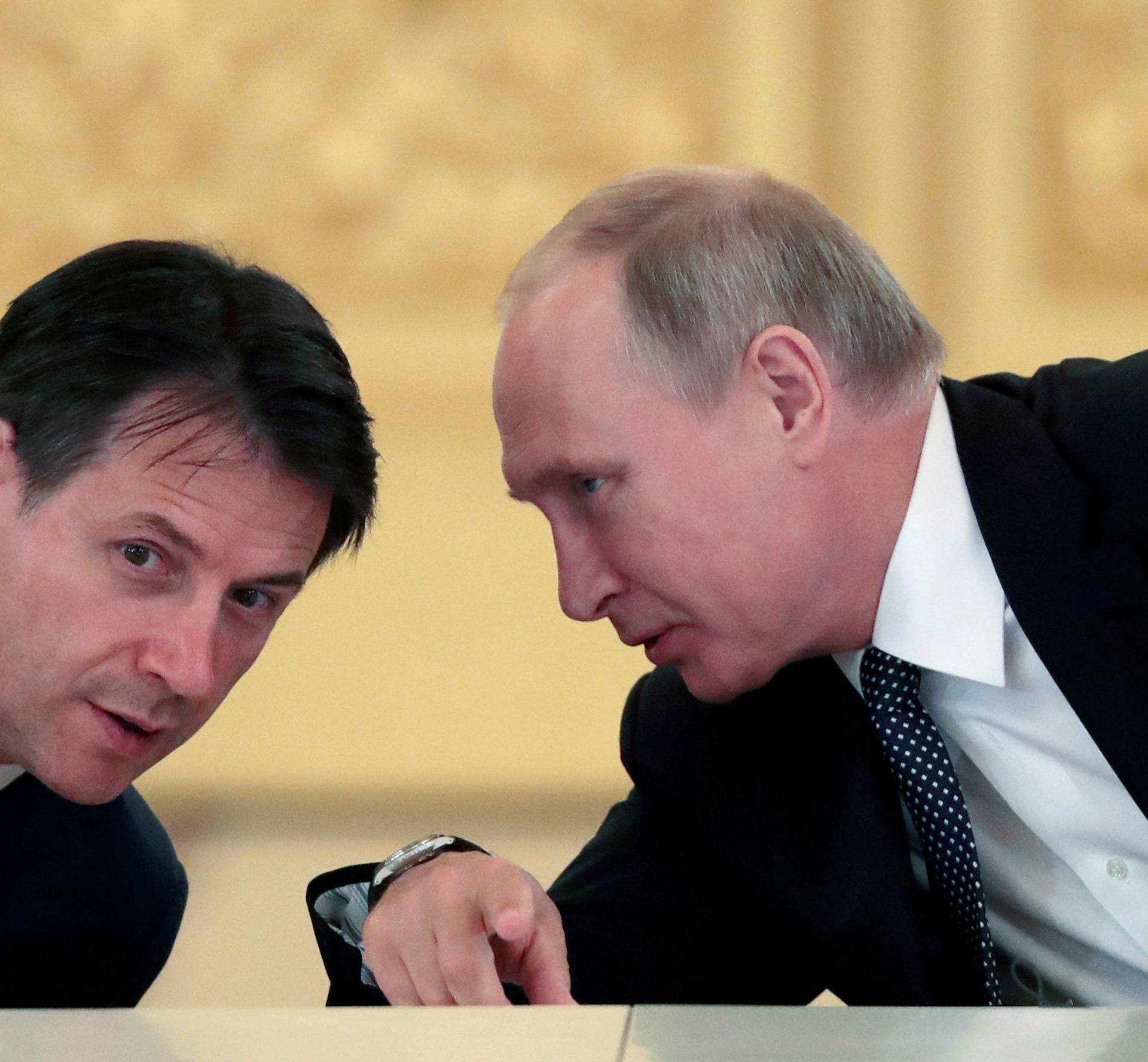 Russian President Putin speaks with Italian PM Conte during a meeting with Italian businessmen in Moscow