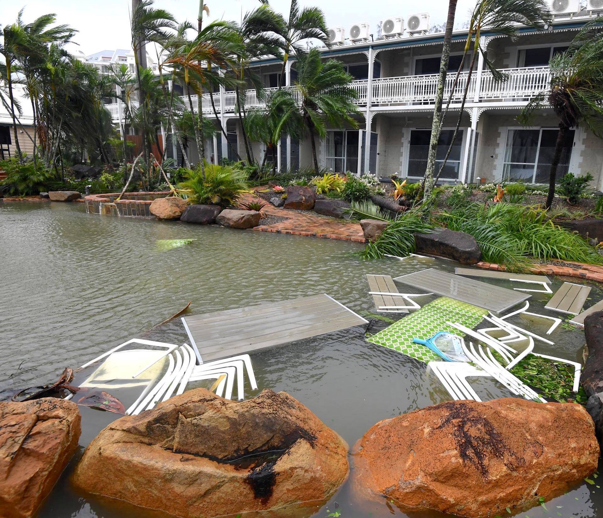 Outdoor furniture lies in a pool at a motel as Cyclone Debbie hits the northern Queensland town of Airlie Beach, located south of Townsville in Australia