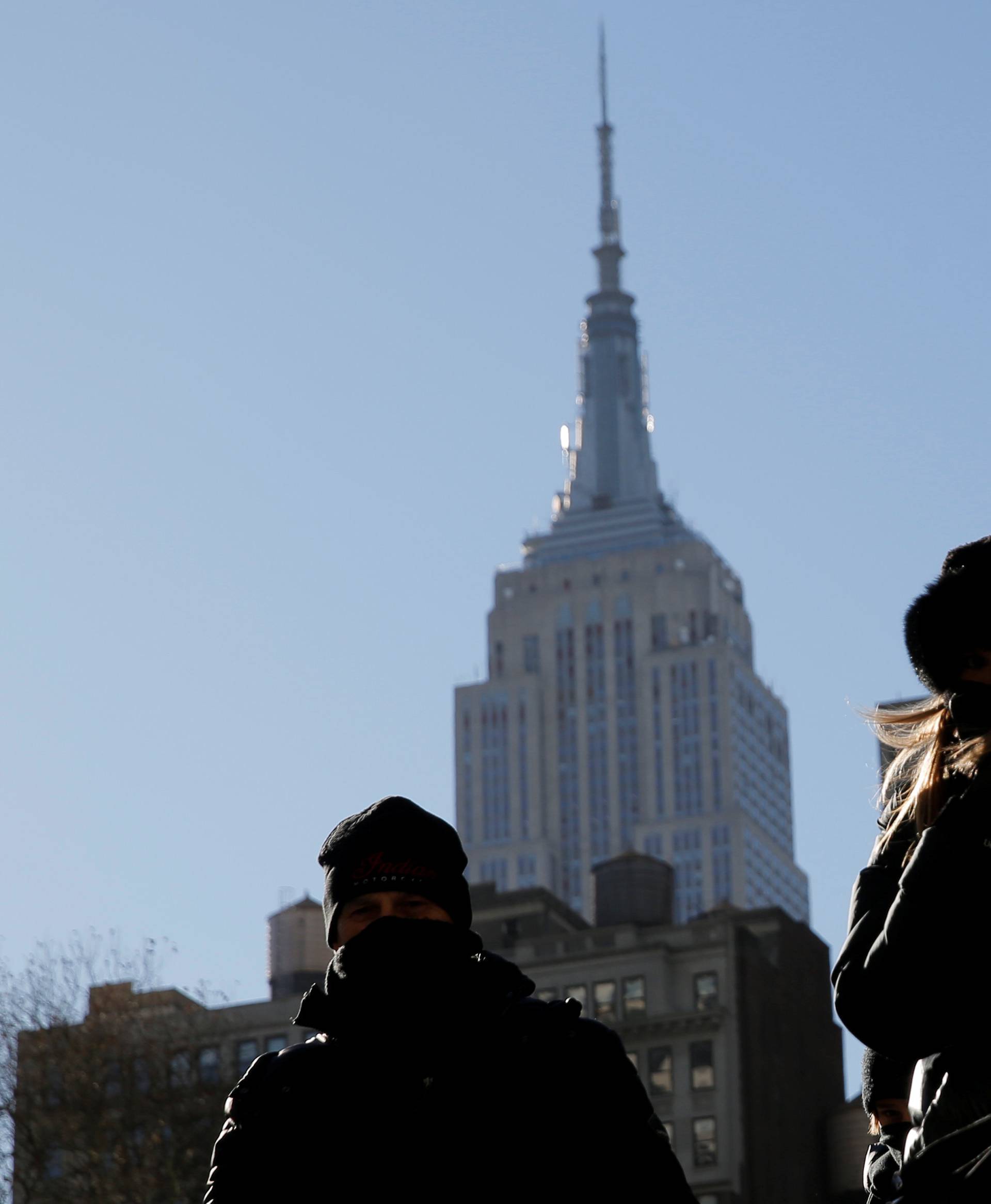 People walk along Sixth Avenue as a cold weather front hits the region in Manhattan, New York