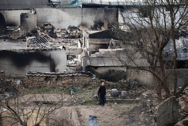 A resident stands near burnt properties after a wildfire devastated the area, in Uiseong