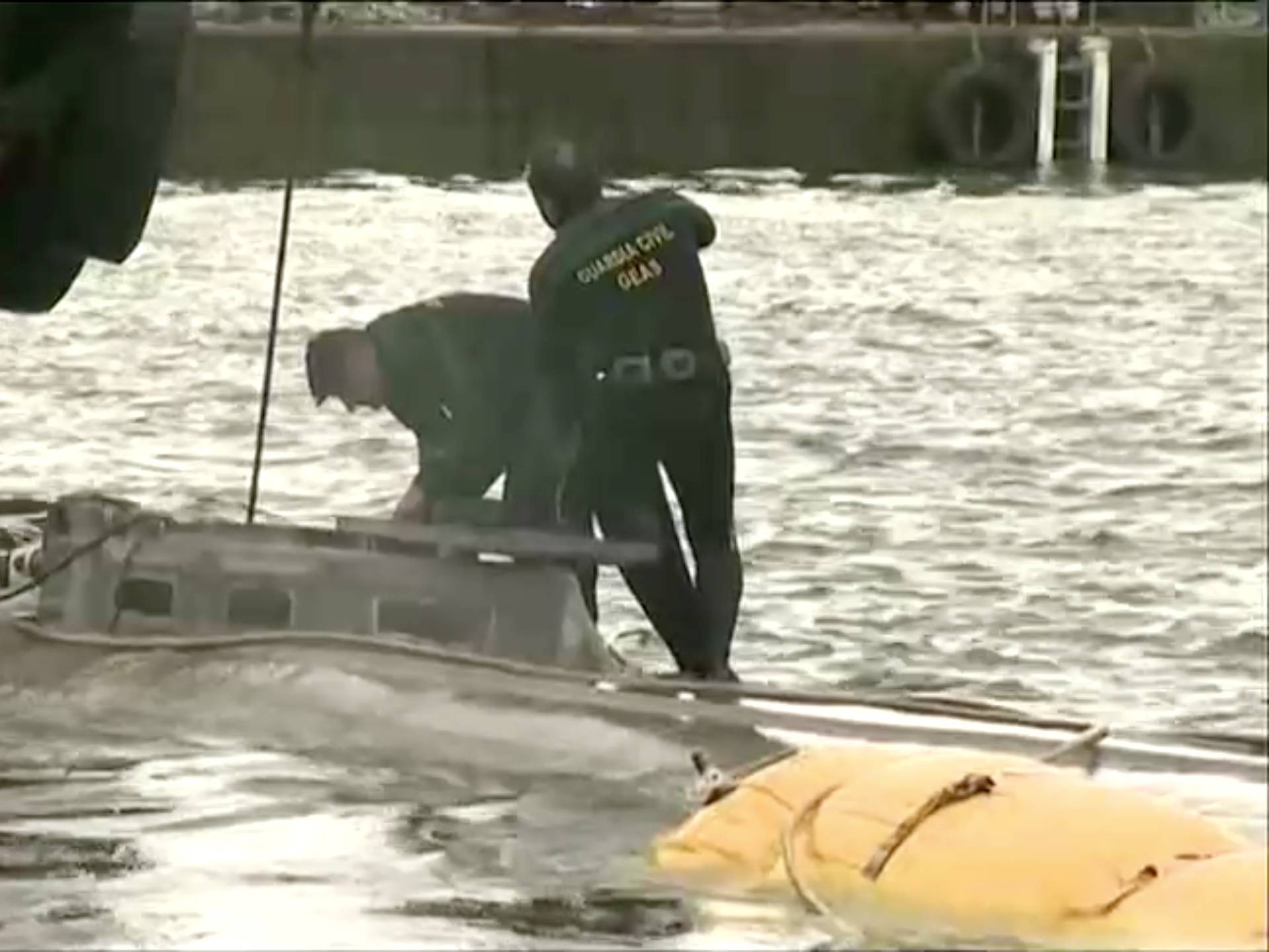 A suspected drug submarine believed to be carrying cocaine is refloated at a port in Aldan