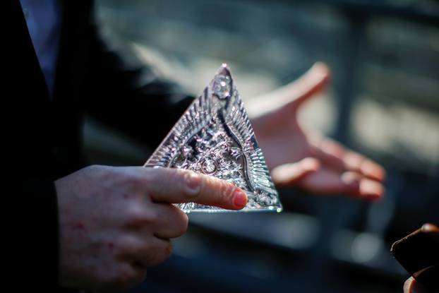 Tom Brennan, Master Artisan of Waterford Crystal, holds a Waterford Crystal triangle from the Times Square New Year
