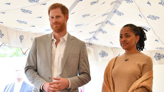 Britain's Prince Harry, and Doria Ragland listen to Meghan, Duchess of Sussex speaking at the launch of a cookbook with recipes from a group of women affected by the Grenfell Tower fire at Kensington Palace in London