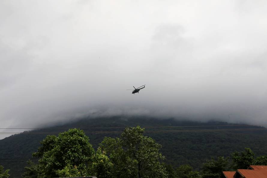 A military helicopter flies near flooded areas after the Xepian-Xe Nam Noy hydropower dam collapsed in Attapeu province