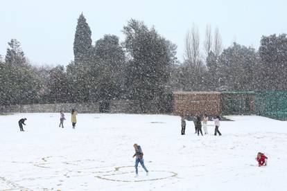 Children play in the snow at Laerskool Orion, a school located in Brackenhurst