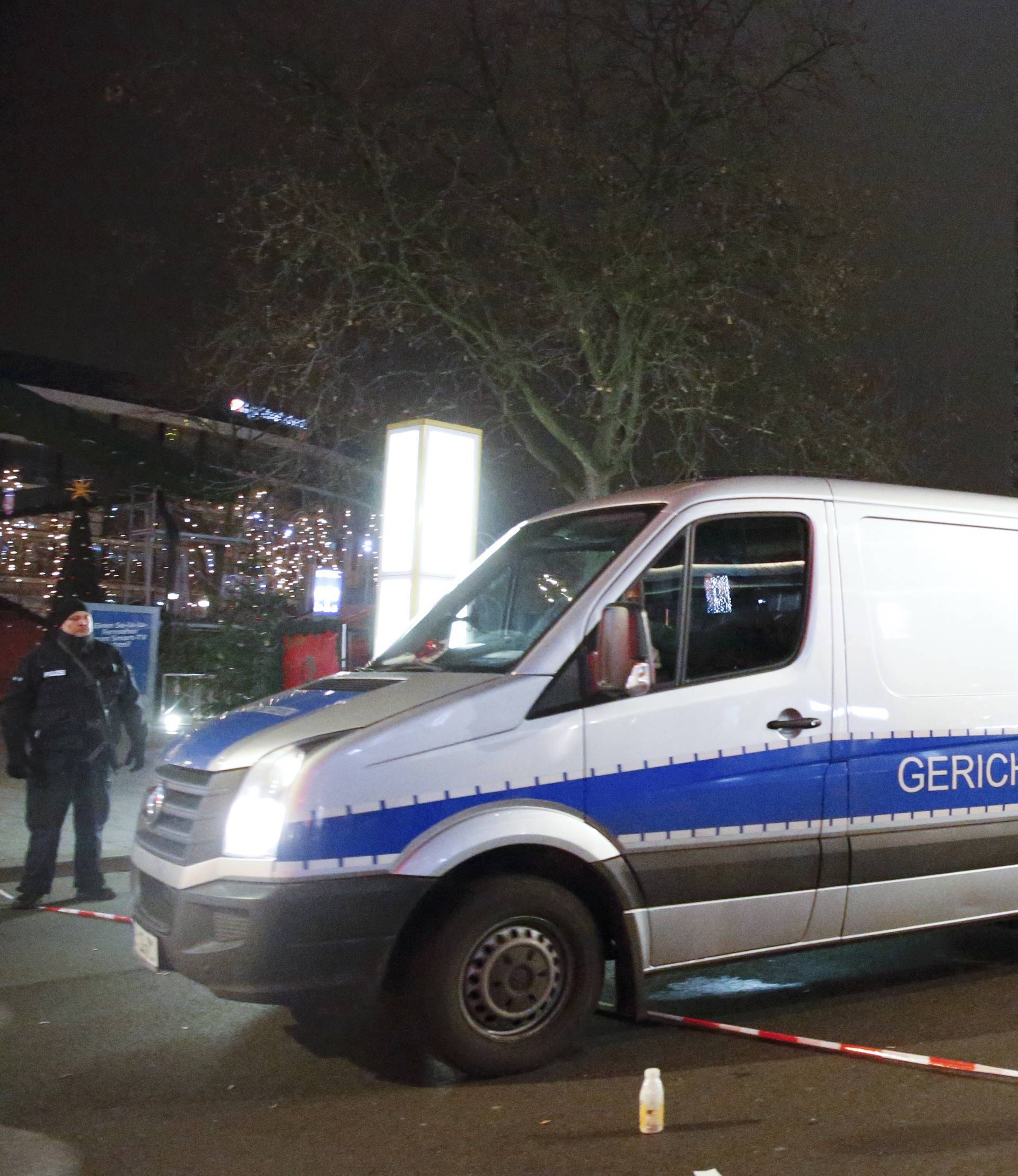 A hearse of the forensic medicine leaves the site where a truck ploughed through a crowd at a Berlin Christmas