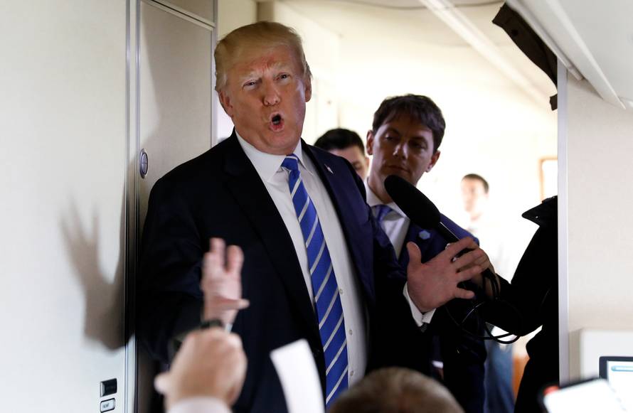 U.S. President Donald Trump speaks aboard Air Force One