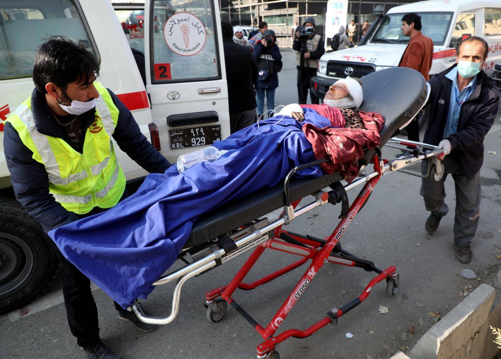 An injured person is carried to a hospital after rockets hit residential areas in Kabul