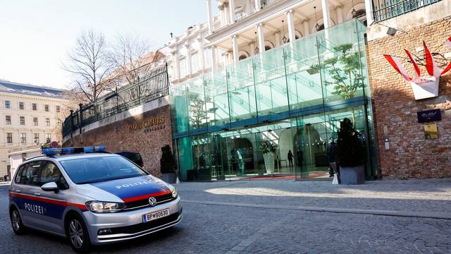 A police car passes the Palais Coburg in Vienna