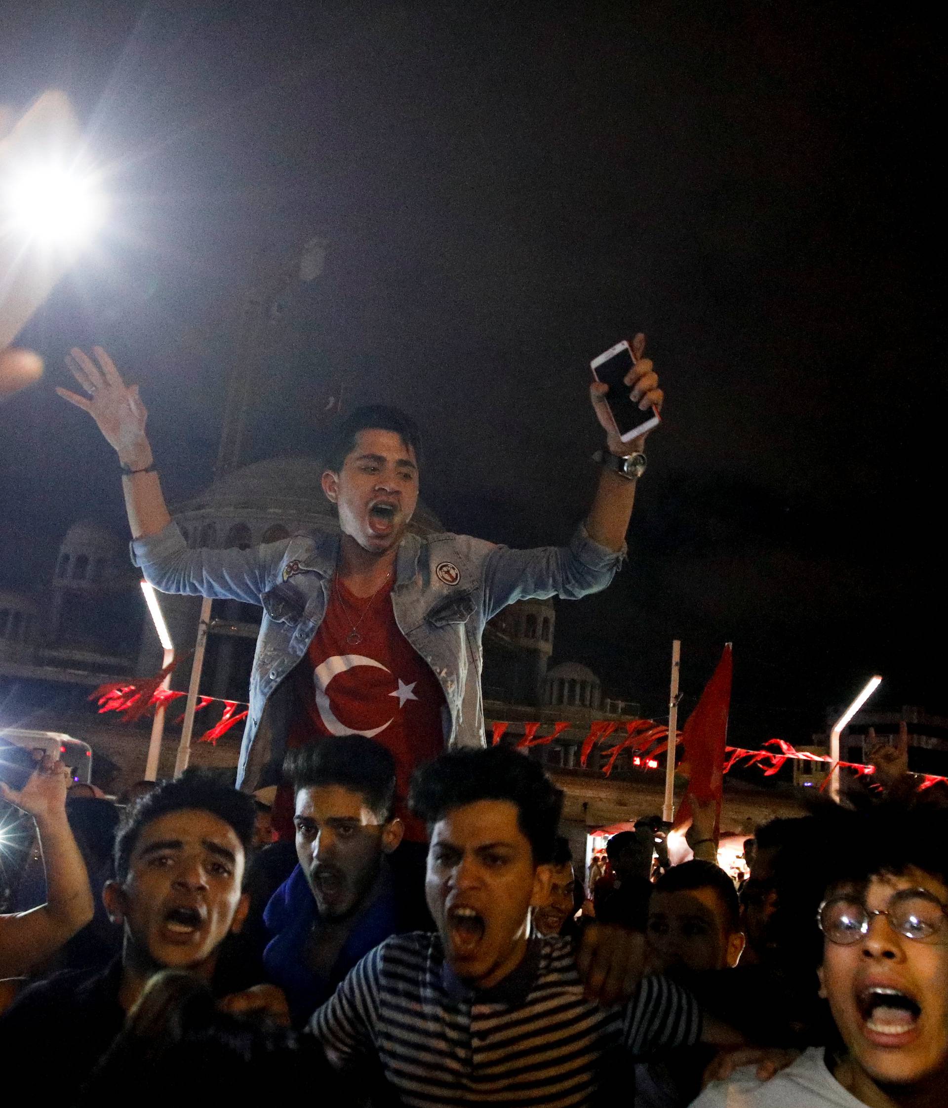 Supporters of Turkish President Tayyip Erdogan celebrate at Taksim square in Istanbul