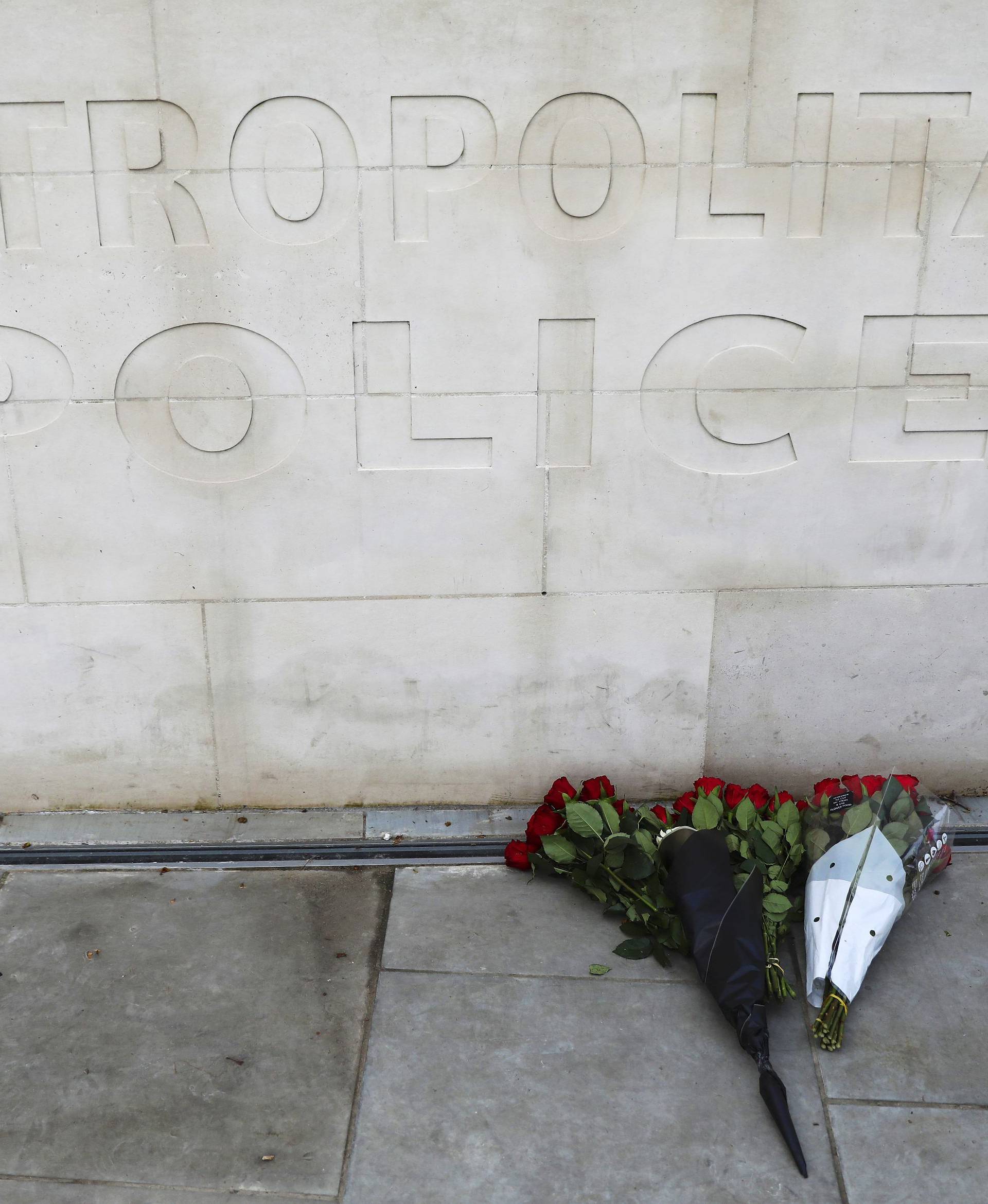 Flowers are left outside New Scotland Yard after a minute's silence the morning after an attack by a man driving a car and weilding a knife left five people dead and dozens injured, in London