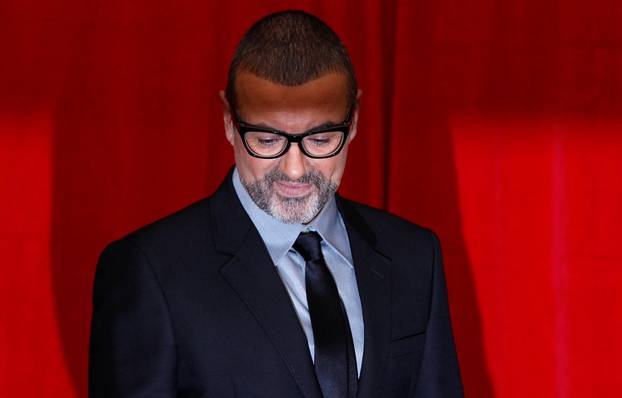 FILE PHOTO British singer George Michael poses for photographers before a news conference at the Royal Opera House in central London