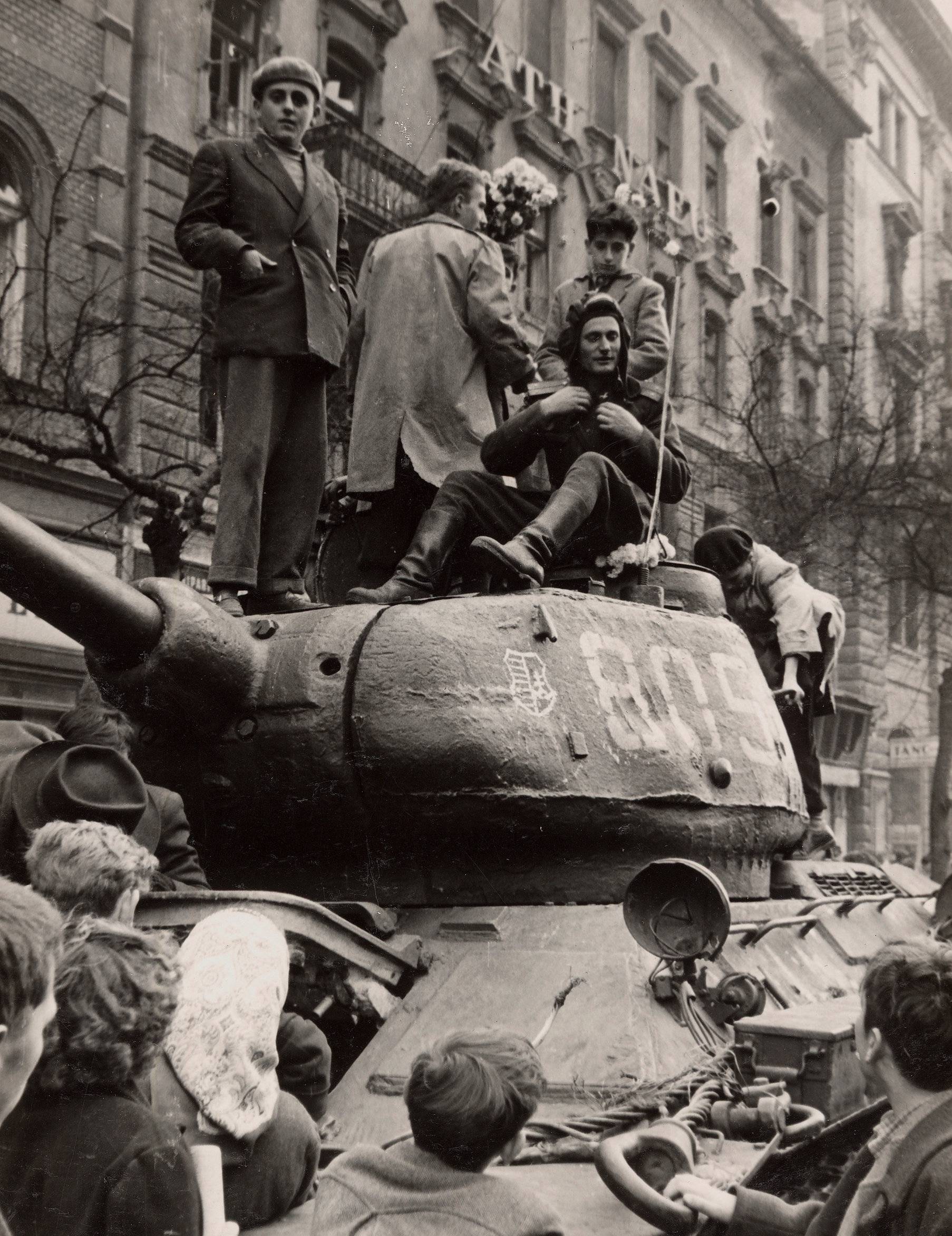 Fighters stand on top of a tank in Budapest at the time of the uprising against the Soviet-supported Hungarian communist regime in 1956
