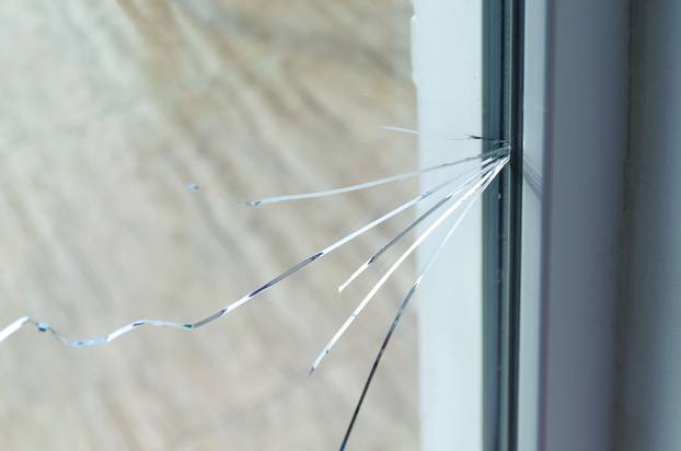 Crack,On,The,Glass,At,A,Residential,House.,Plastic,Window