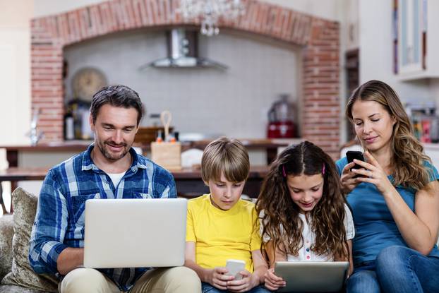 Parents,And,Kids,Using,A,Laptop,,Tablet,And,Phone,At