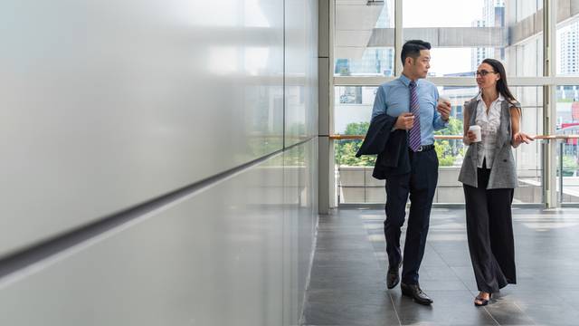 Business,People,Walking,In,Hallway,With,Big,Windows,Stock,Photo