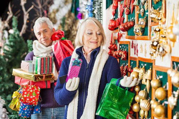 Senior,Woman,Shopping,Christmas,Ornaments,At,Store,With,Man,Holding