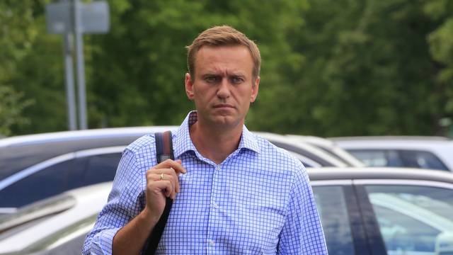 FILE PHOTO: Russian opposition leader Navalny walks before a court hearing in Moscow
