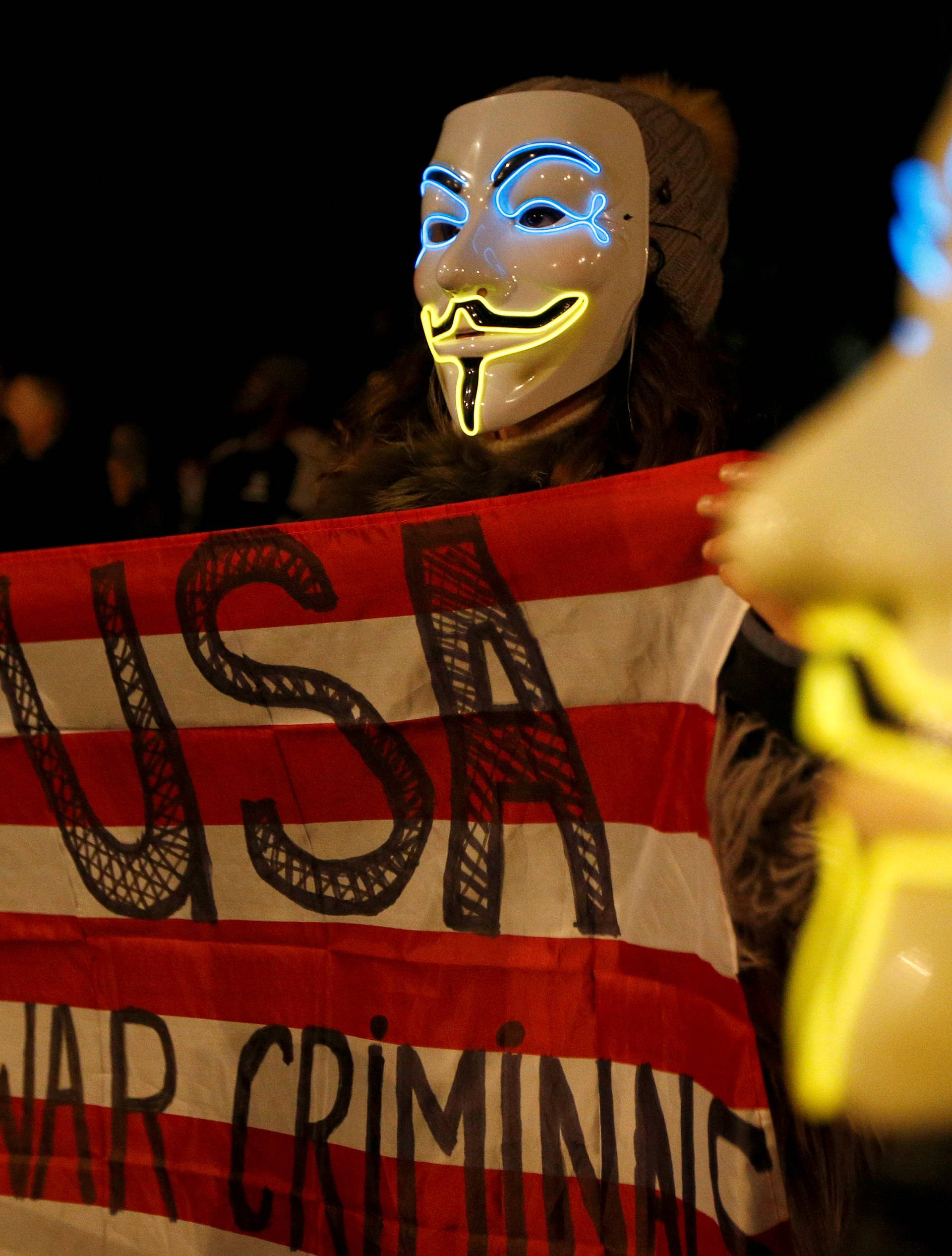 Protesters wave an anti US flag during the "Million Mask March" in London