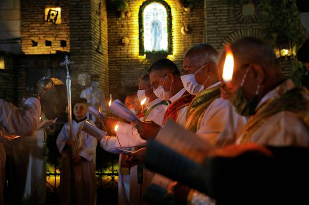 Iraqi Christians hold a mass on Christmas Eve
