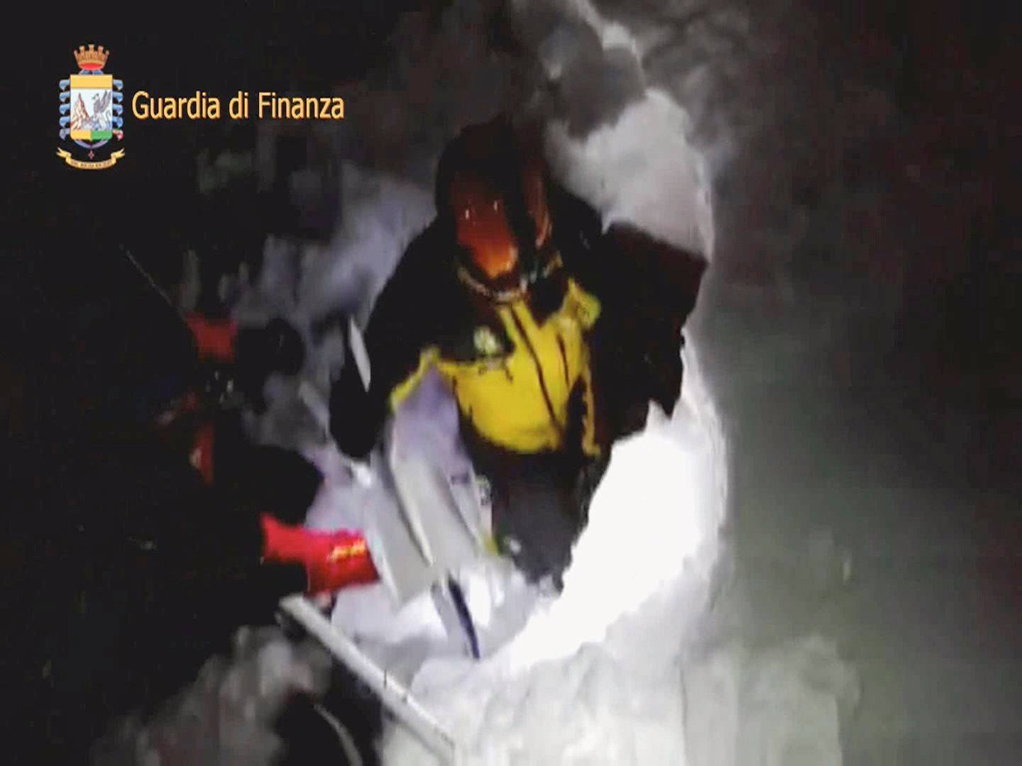A photo taken from a video shows a rescuer entering the Hotel Rigopiano in Farindola, central Italy, hit by an avalanche