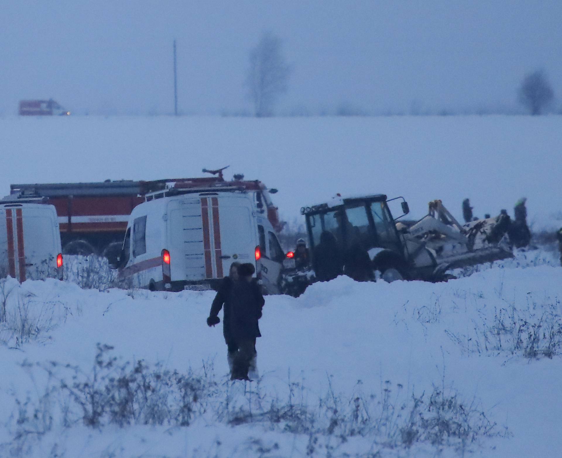 Emergency services work at the scene where a short-haul regional Antonov AN-148 plane crashed after taking off from Moscow's Domodedovo airport, outside Moscow