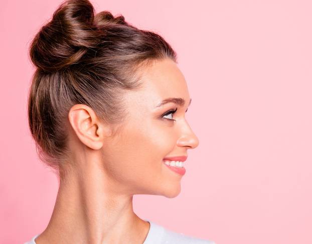 Close-up profile side view of nice lovely cute fascinating attractive groomed cheerful cheery girl looking aside copy empty blank space place isolated over pink pastel background