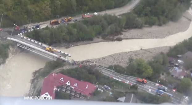 A still image shows a bridge damaged by floodwaters in a settlement in Krasnodar Region