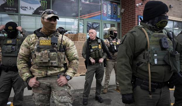 Border Patrol commander Greg Bovino's convoy stops at a gas station in Columbia Heights