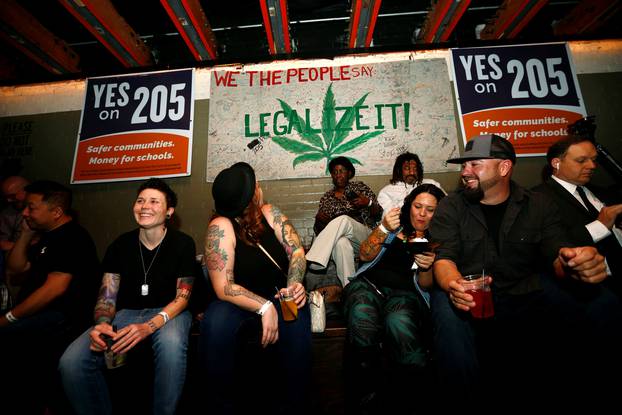People gather for an election watch party put on by supporters of a legal marijuana initiative in Phoenix, Arizona