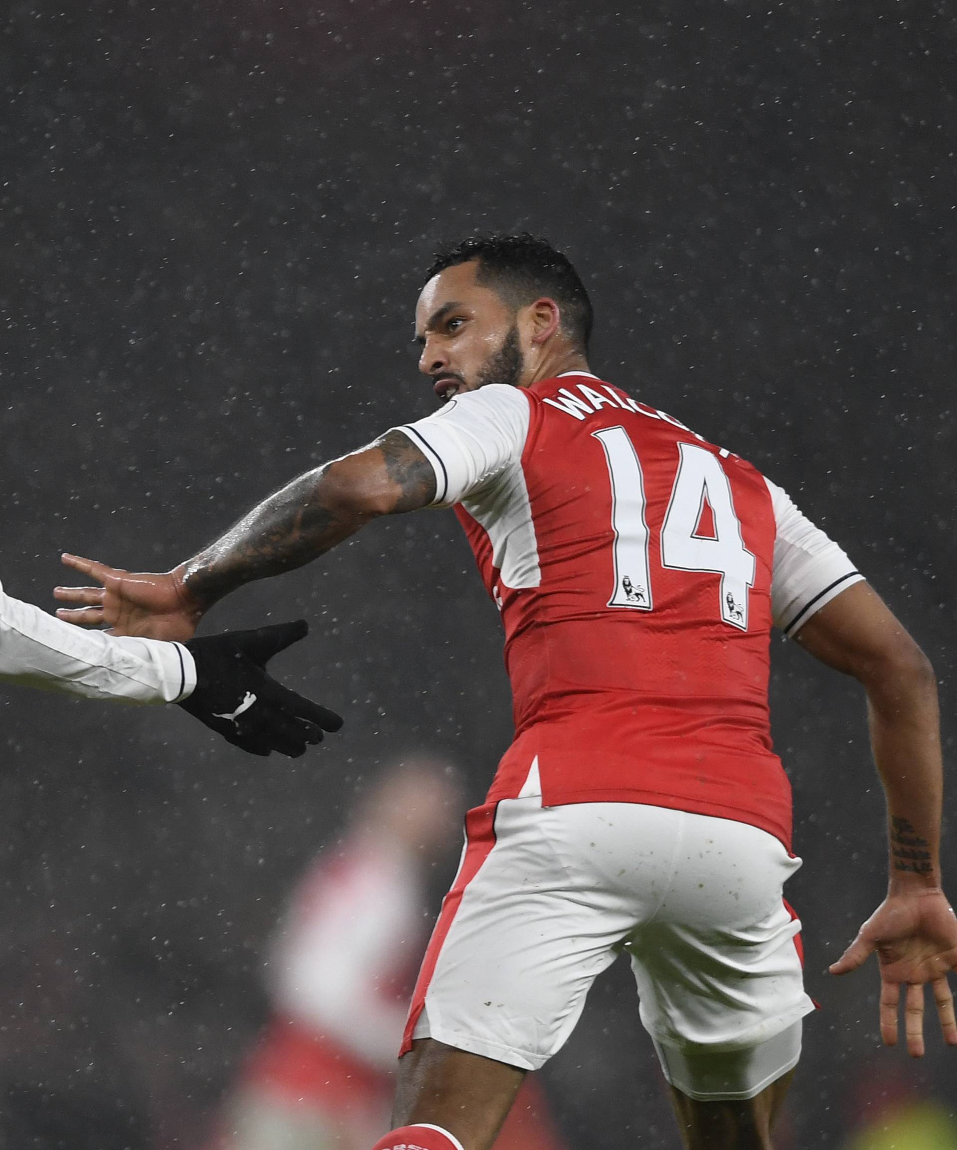 Arsenal's Alex Iwobi celebrates scoring their first goal with Theo Walcott