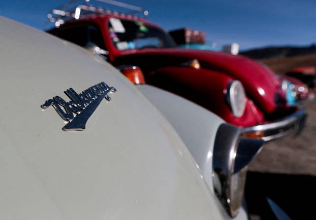 Bolivian Volkswagen Beetle fans drive through Cordillera Real mountain range towards the Amazon