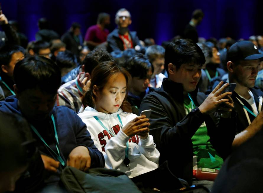 Attendees work on their devices before Apple Inc.'s 2016 Worldwide Developers Conference in San Francisco, California