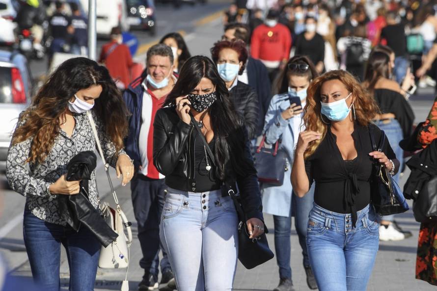 People wear face masks after the southern Italian region of Campania made it mandatory to wear protective face coverings outdoors 24 hours a day, to contain the coronavirus disease (COVID-19) outbreak