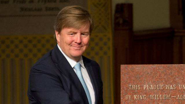 Dutch King Willem-Alexander, left, and OPCW Director-General Ahmet Uzumcu unveil a commemorative plaque during a ceremony marking the OPCW's 20th anniversary, in The Hague